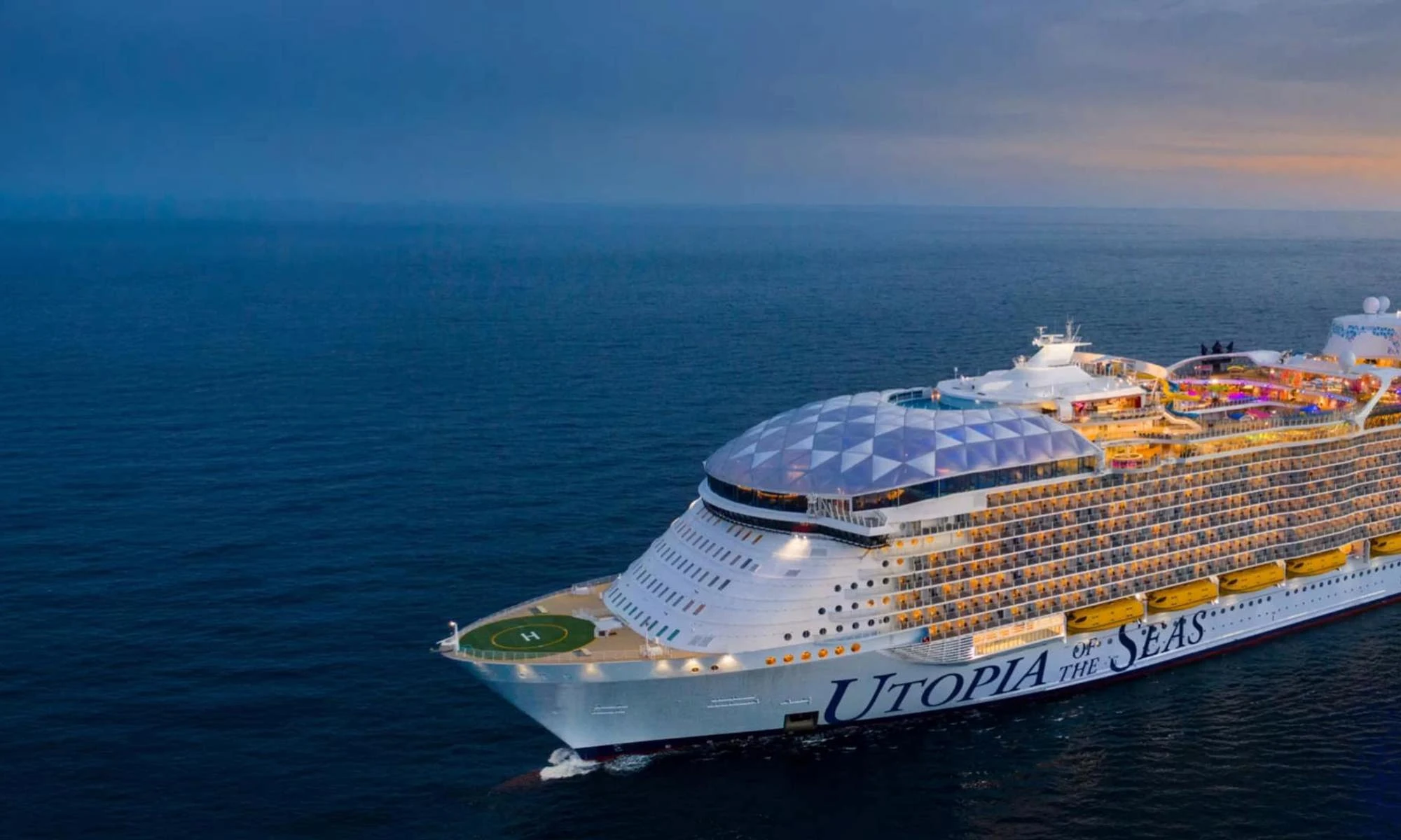 Utopia of the Seas sailing on open water at sunset