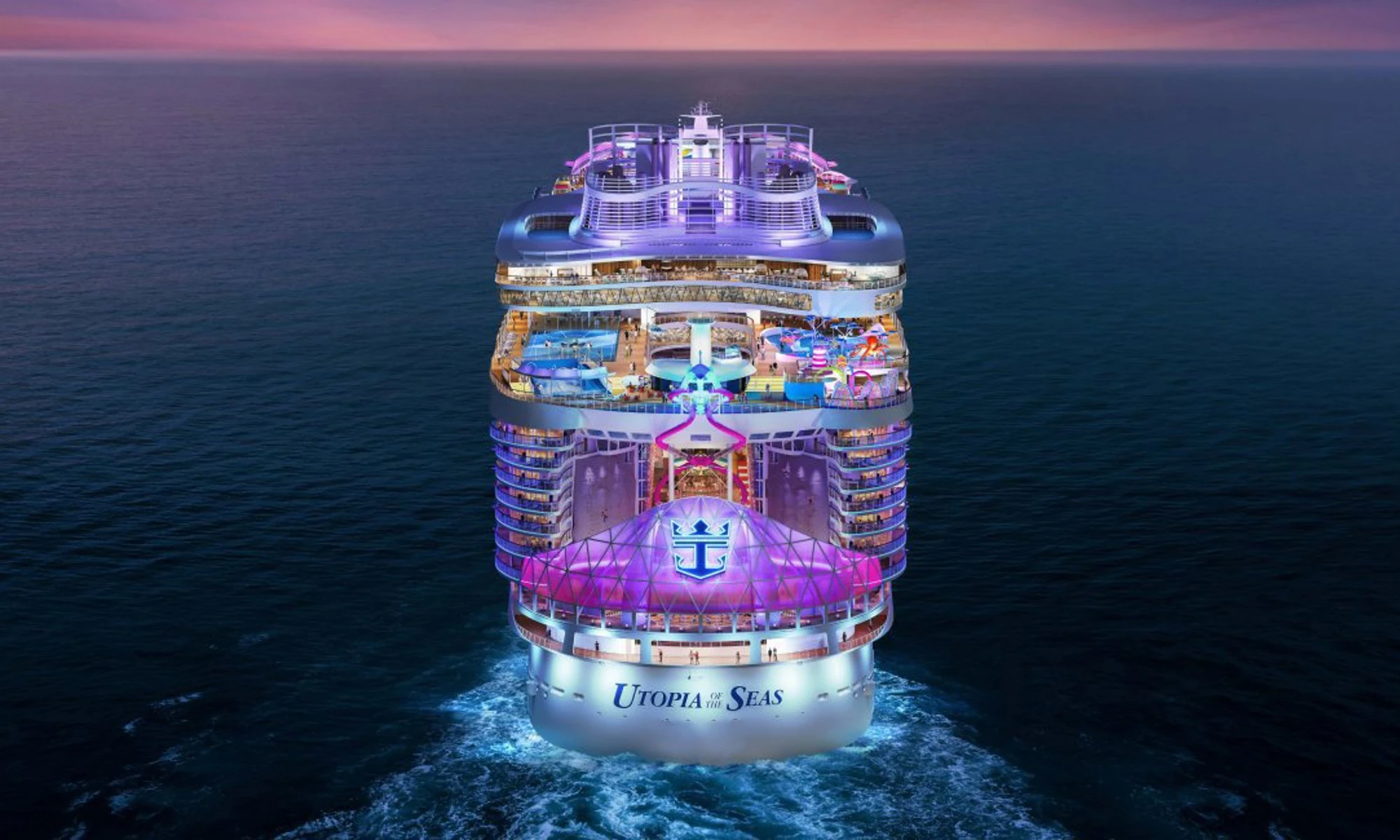 Aerial view of Utopia of the Seas lit up at dusk